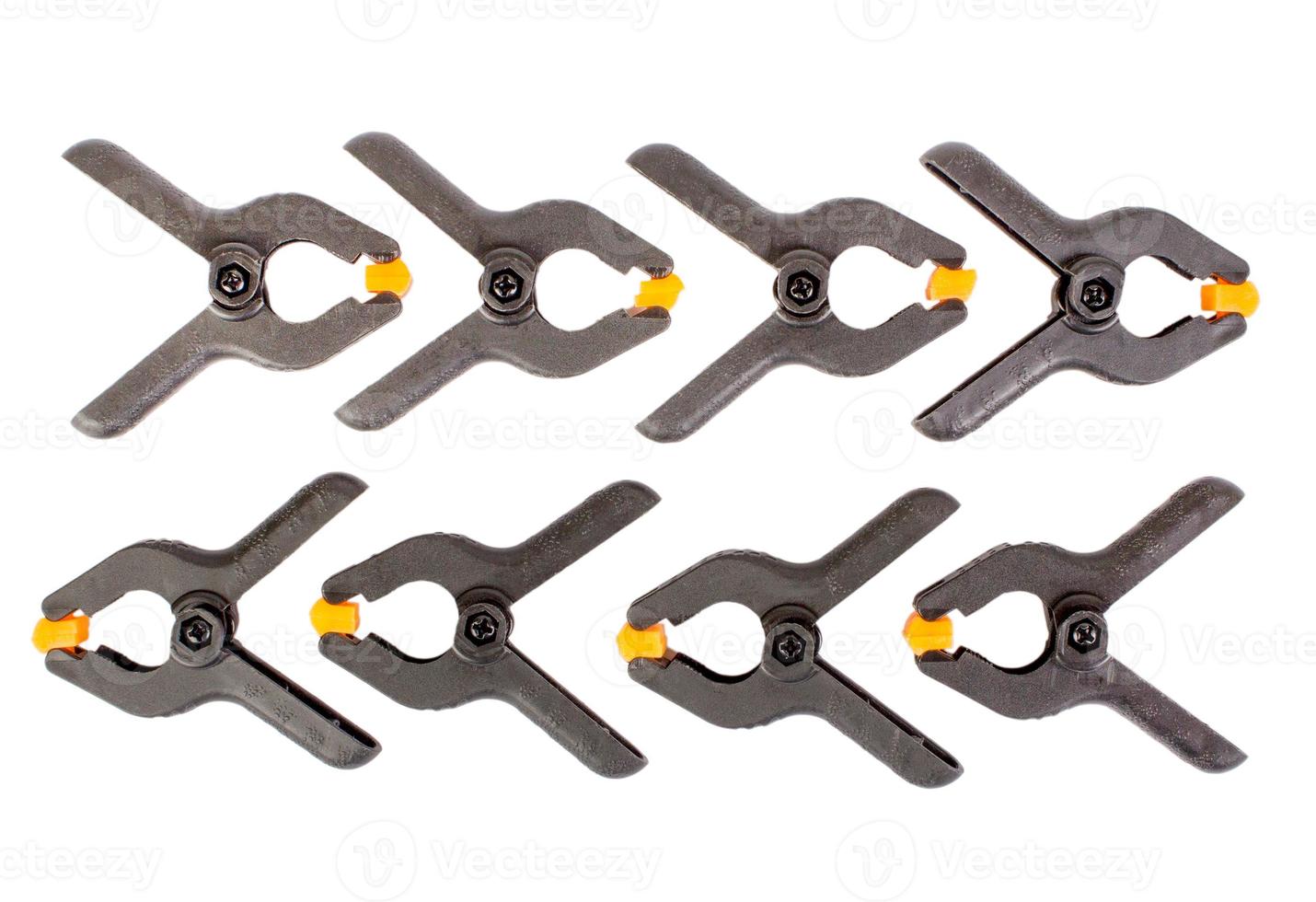 Universal plastic black-orange clamp isolated photo