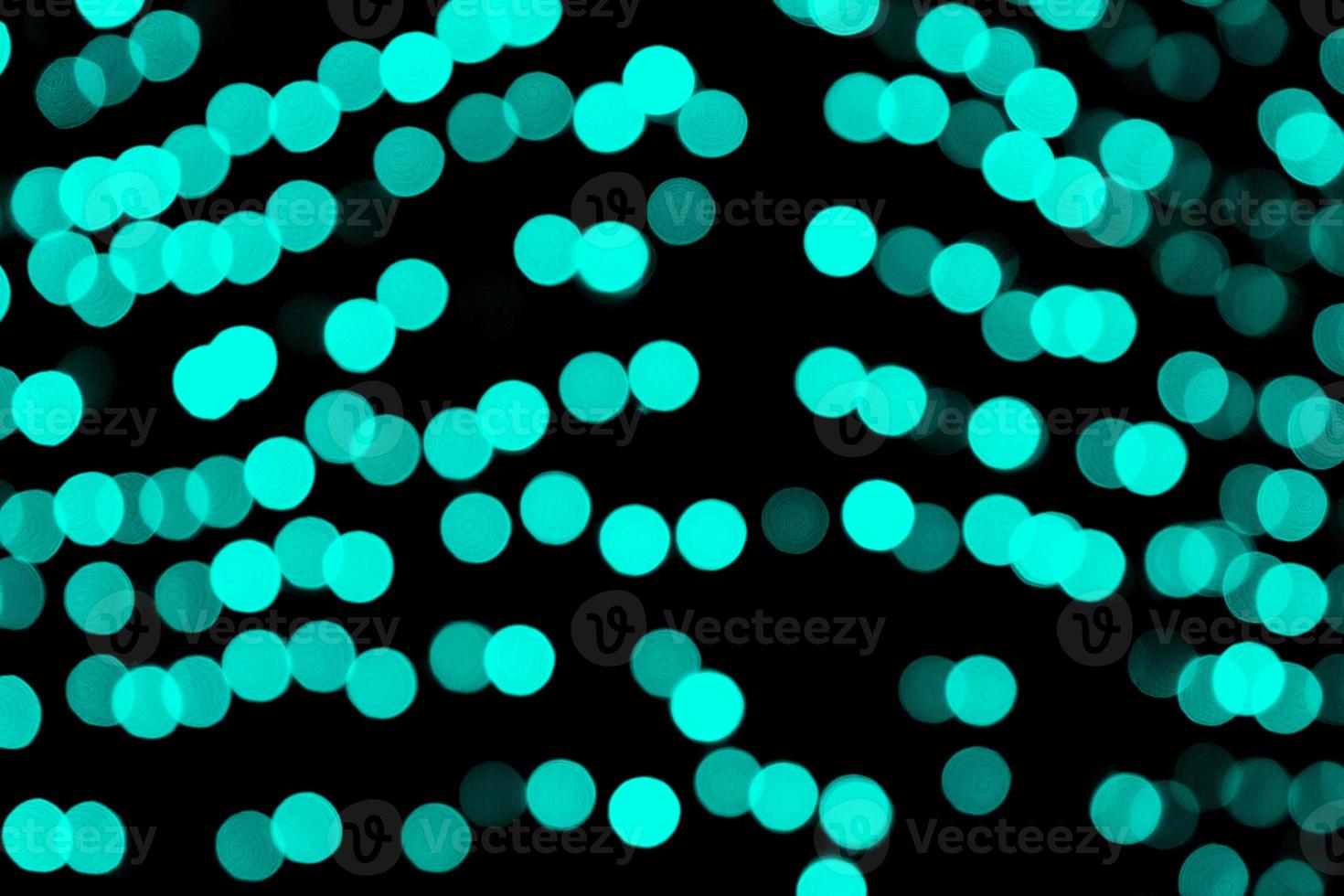 Unfocused abstract colourful bokeh black background. defocused and blurred many round blue light photo