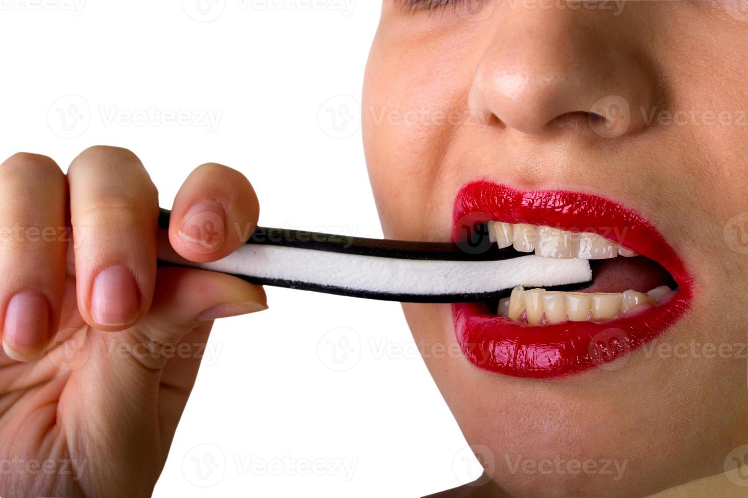 Sexy woman with red lips holding lollipop photo