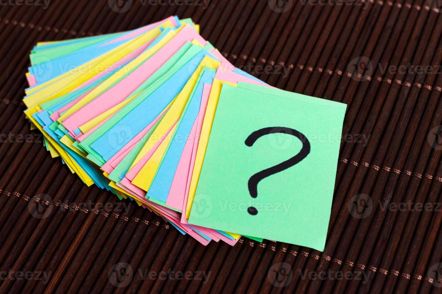 colorful question marks written reminders tickets on wooden background photo