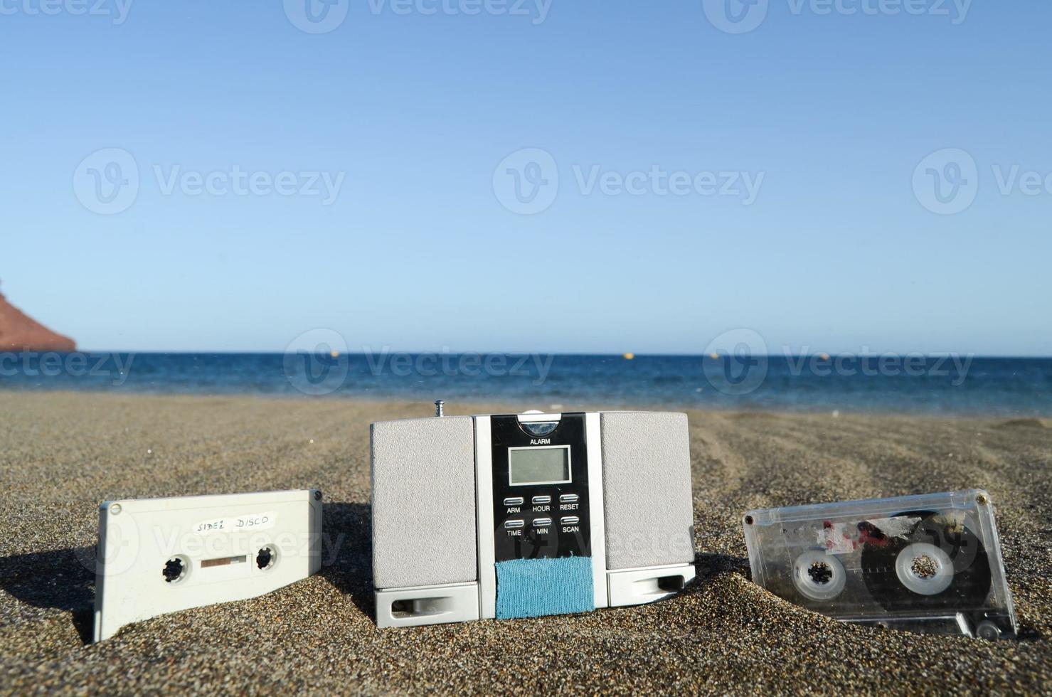 Radio and cassette tapes on the beach photo