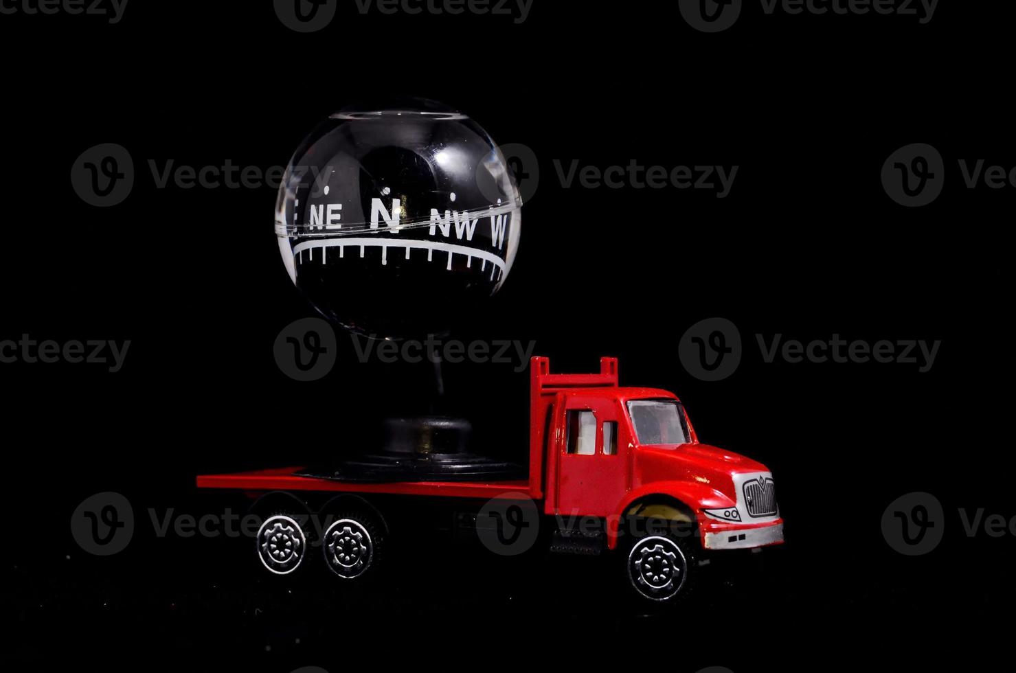 Red toy truck carrying a compass photo