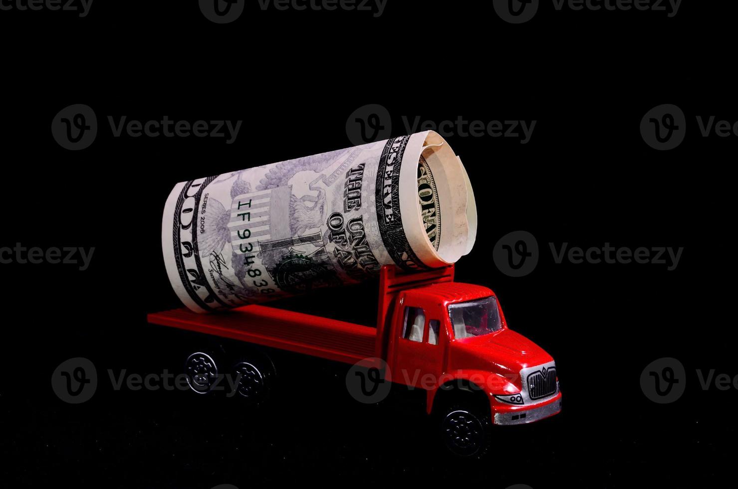 Red toy truck carrying cash photo