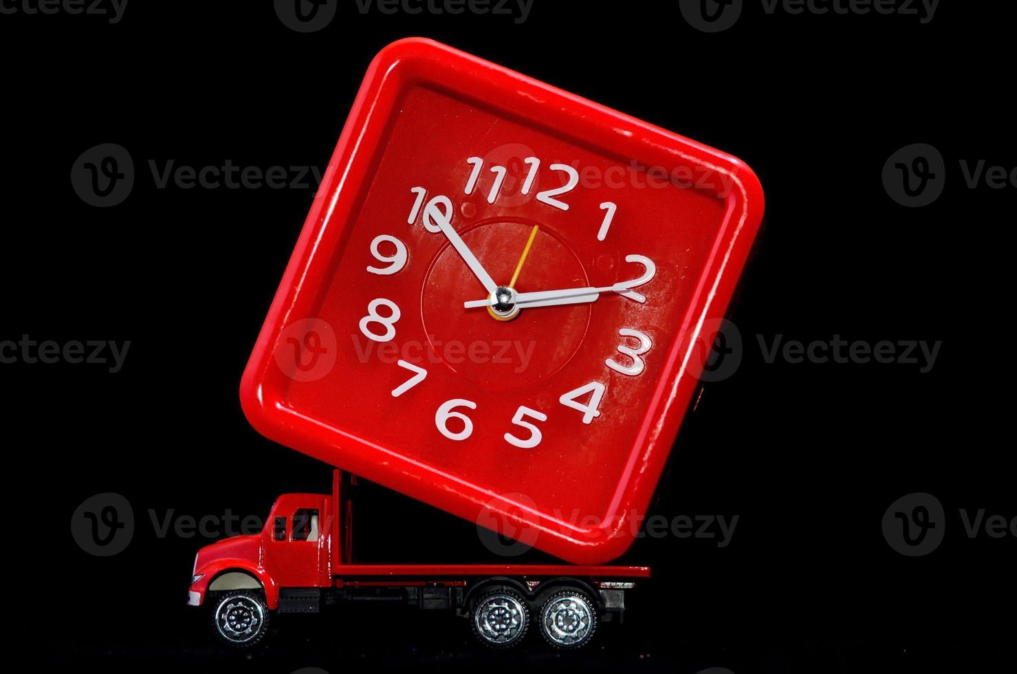 Red toy truck carrying a clock photo