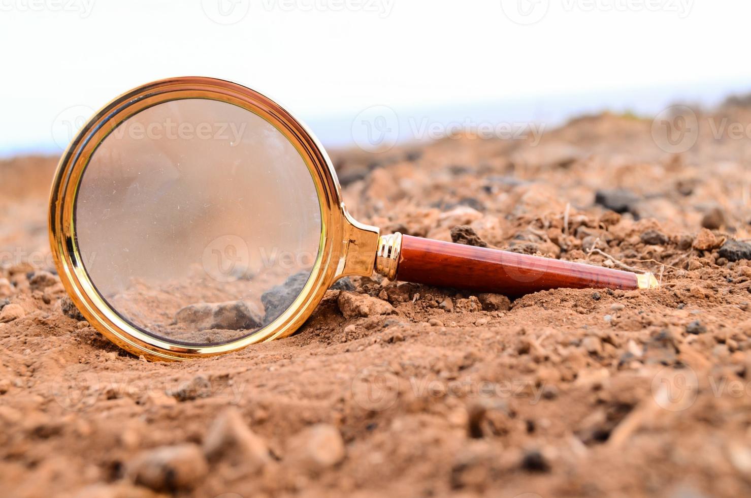 Magnifying glass on the ground photo