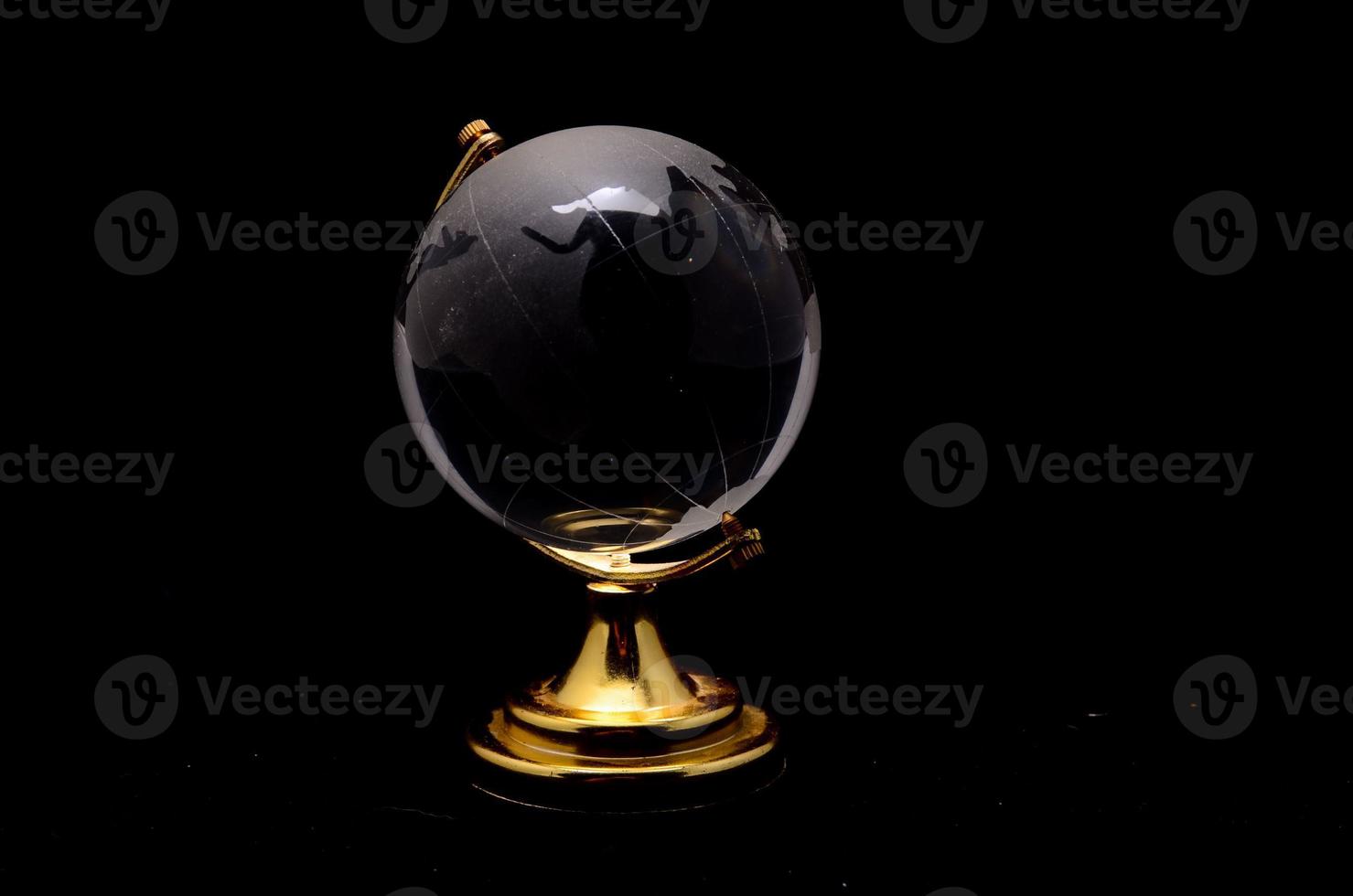 Glass globe on black background photo