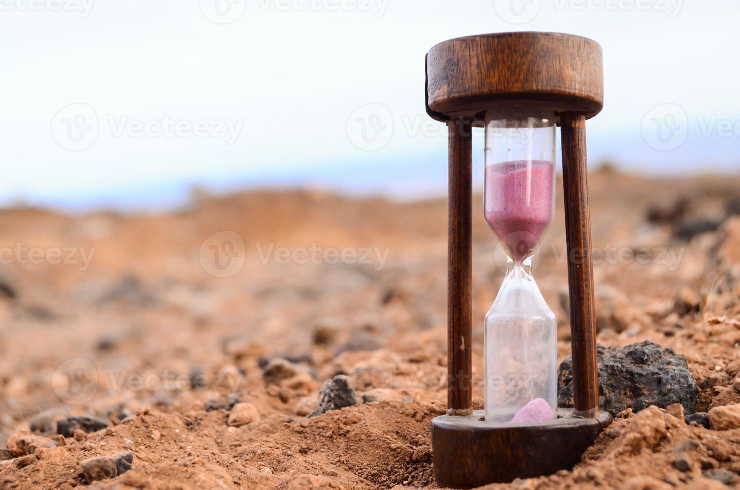 Hourglass on he sand photo