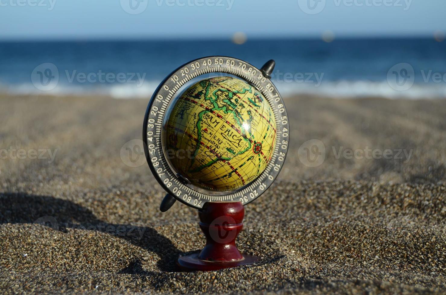 Globe on the sand photo