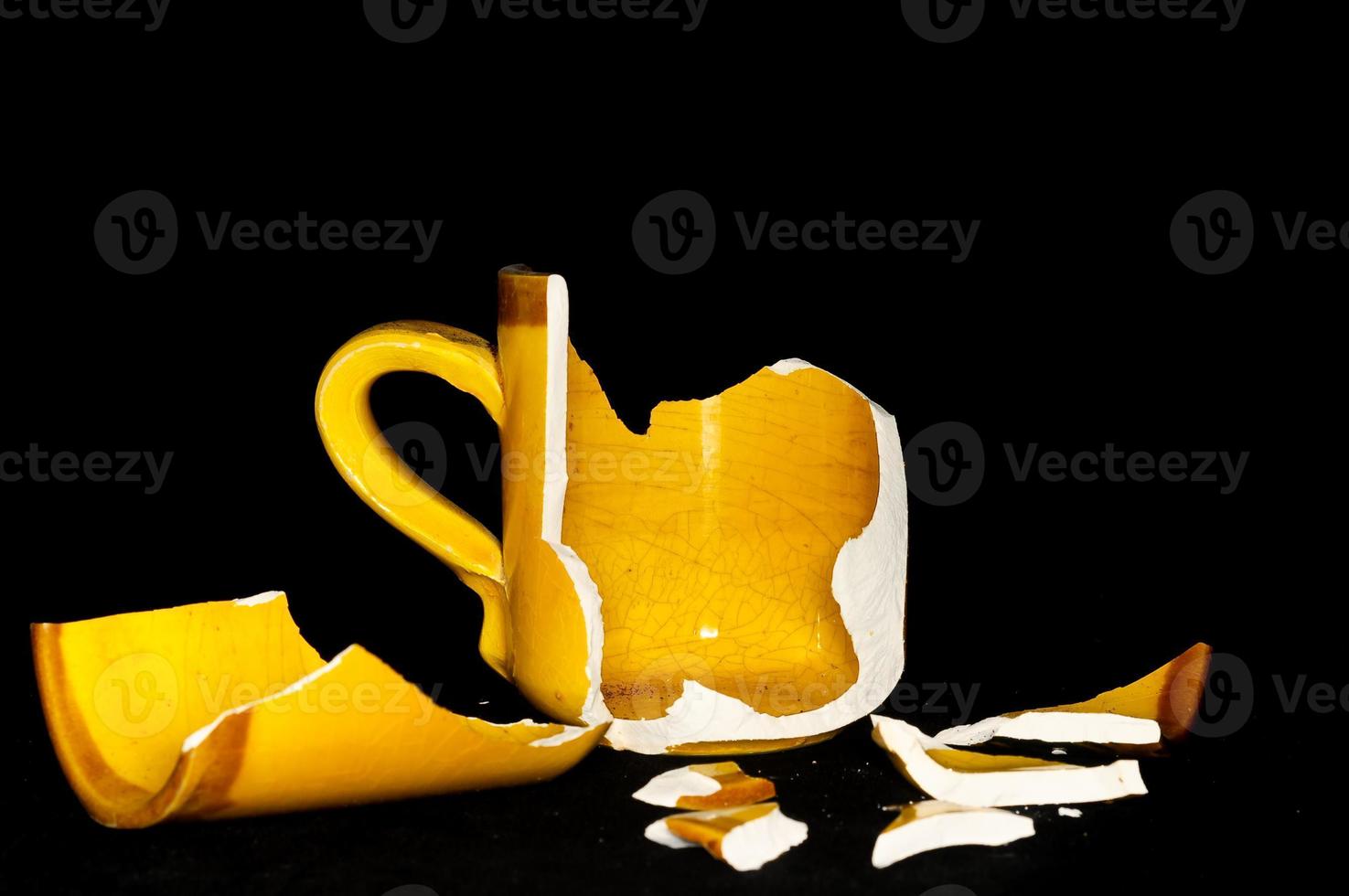 Broken mug on black background photo