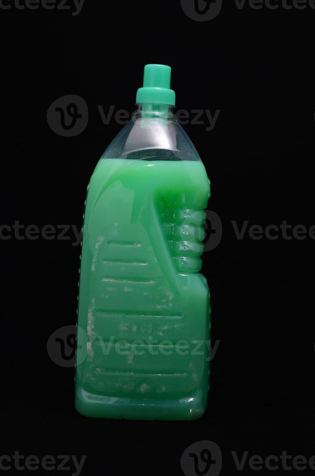 Cleaning product bottle on dark background photo