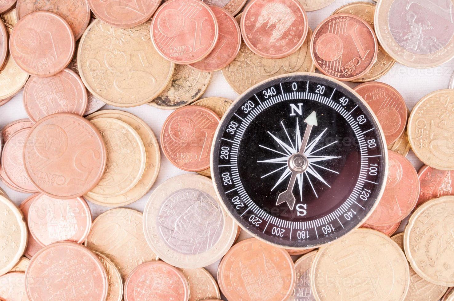 Compass on coin background photo