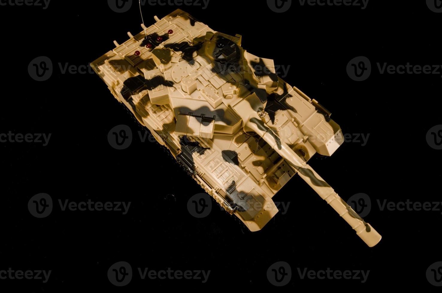 Camo tank on black background photo