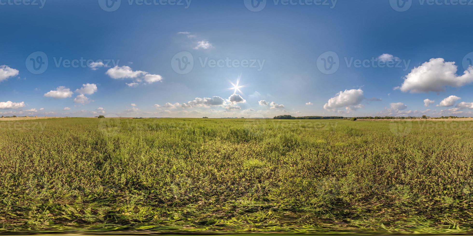 full seamless 360 hdri panorama view among farming field with sun and clouds in overcast sky in equirectangular spherical projection, ready for use as sky replacement in drone panoramas or VR content photo