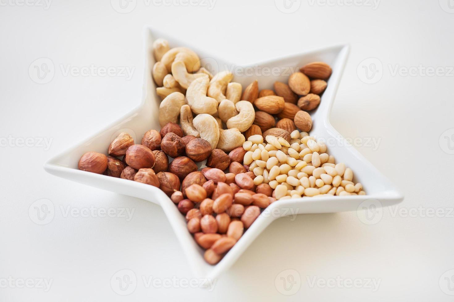 Mixed nuts in a dish in form of stars, close-up photo