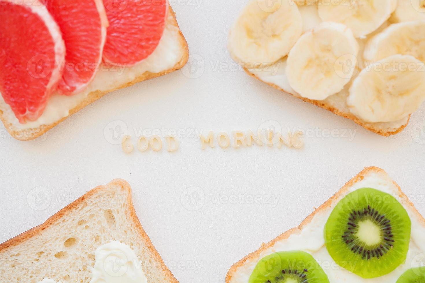 bright mix sandwiches for breakfast fruit, vegetables, fish inscription good morning photo