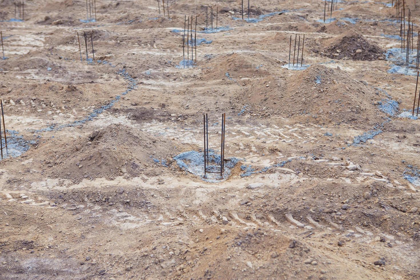 Foundation site of new building, details and reinforcements with steel bars and wire rod, preparing for cement pouring. photo