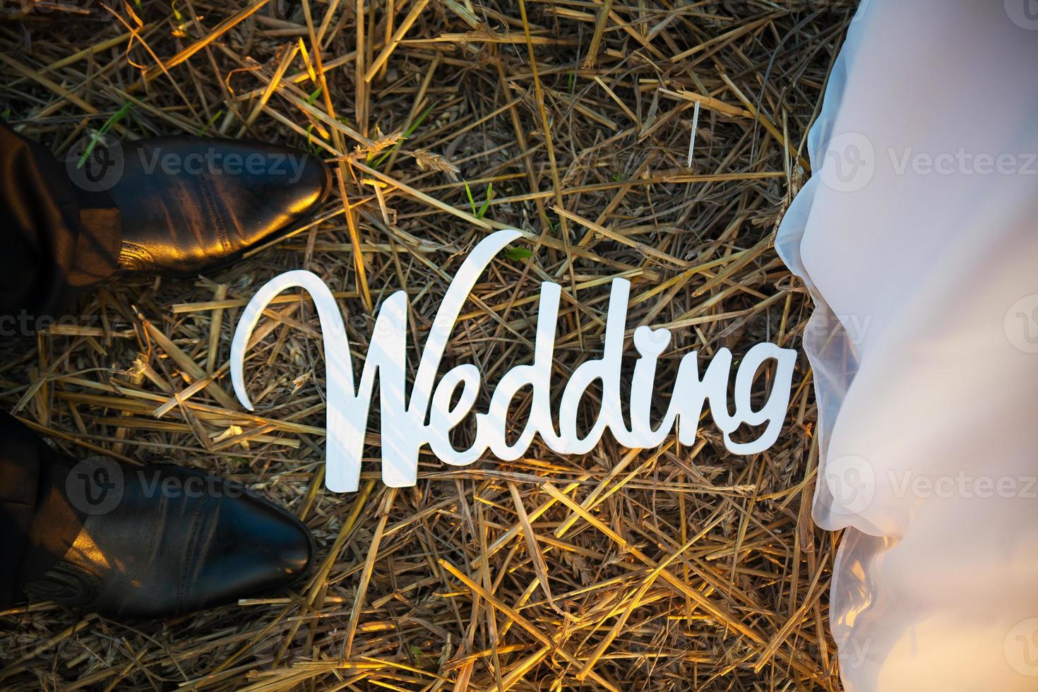 Feet of groom and bride. White wedding letters photo