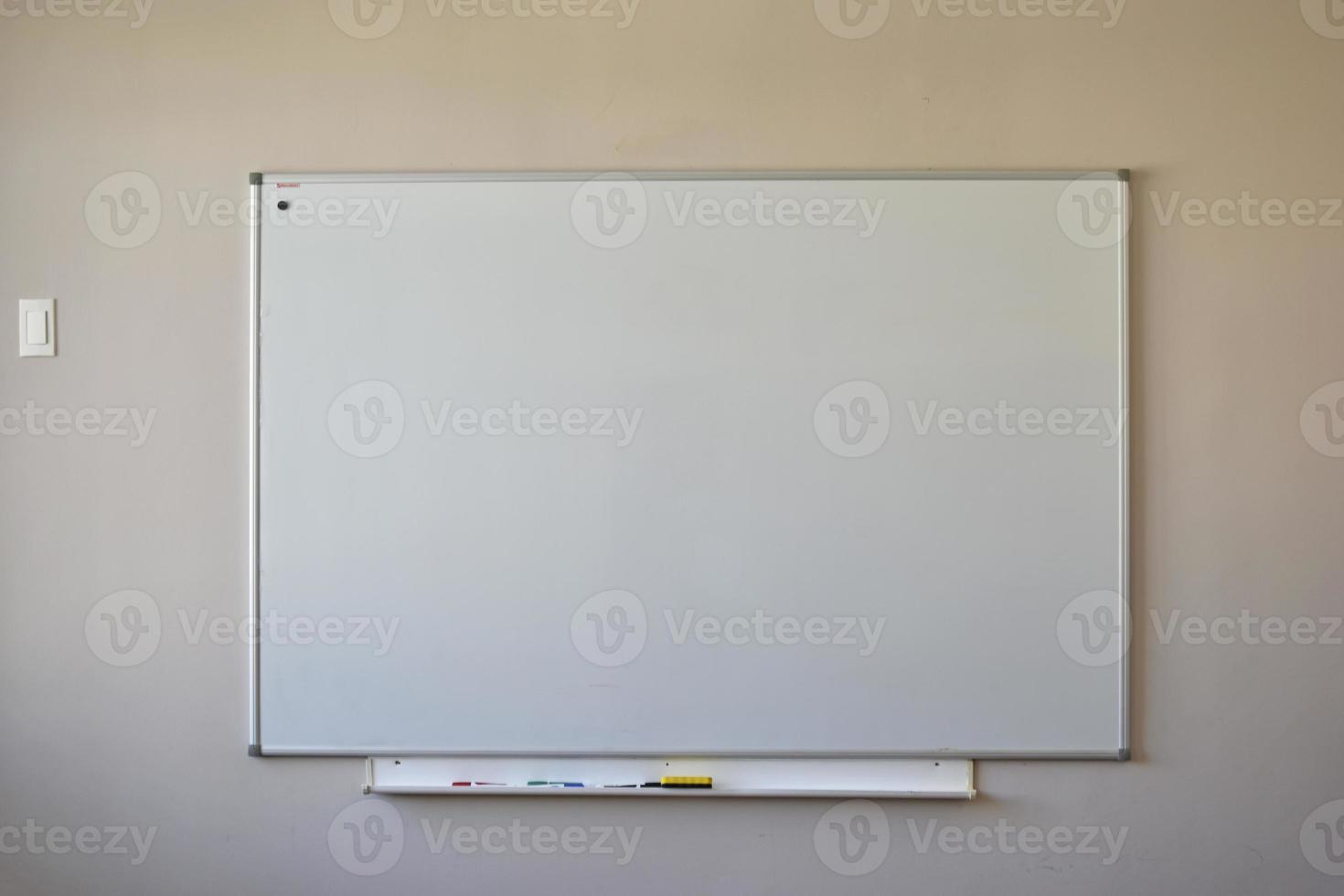 A white chalkboard for writing texts with a felt-tip pen. School iron board in the classroom. photo