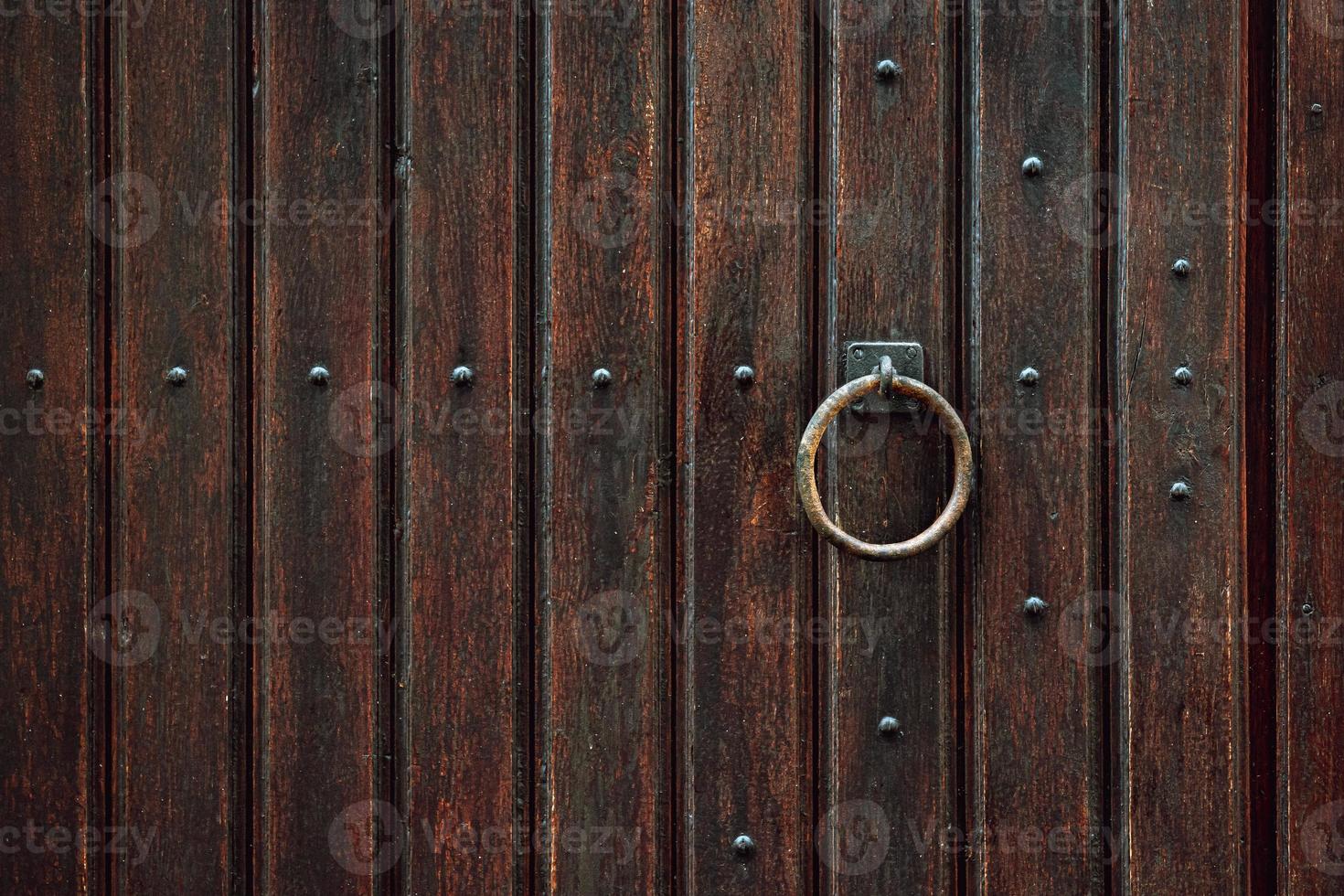 Wooden door with iron handles. Ancient wooden door. Detail of a wooden background. photo