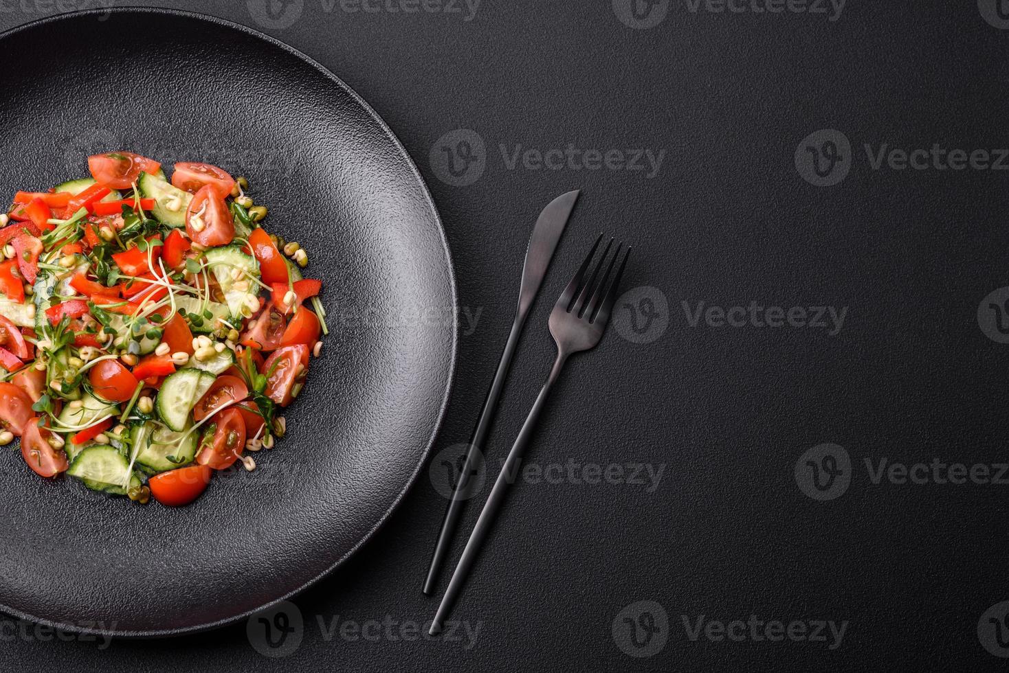 Delicious juicy fresh salad of tomatoes, peppers, cucumber, microgreens and sprouted mung bean photo