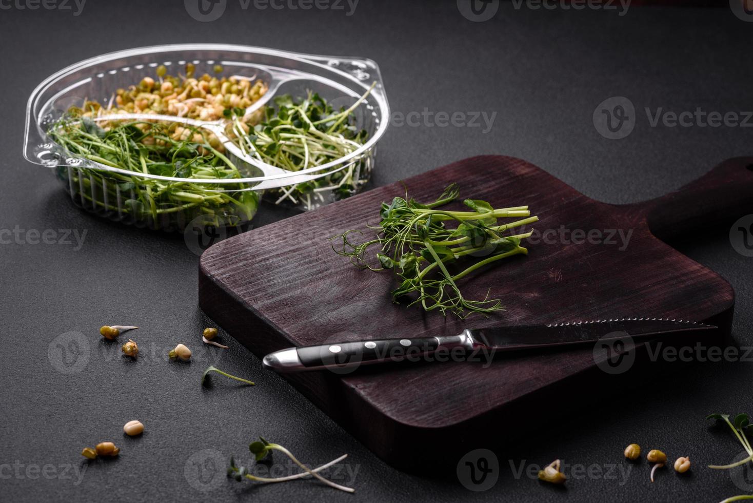 A set or mix of pea, mustard and sprouted mung bean microgreens in a portioned plastic box photo