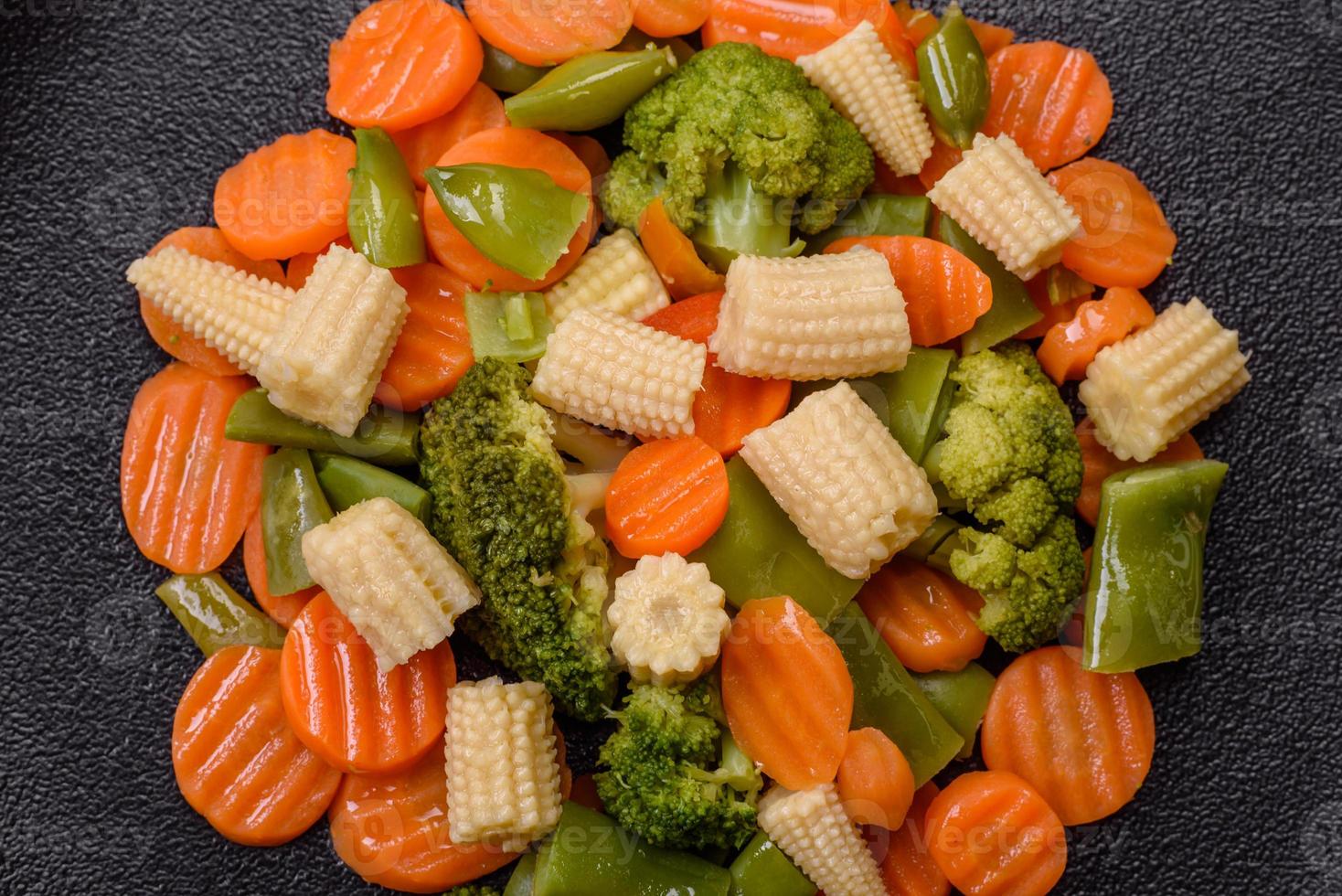 A mixture of vegetables carrots, small heads of corn, asparagus beans steamed photo