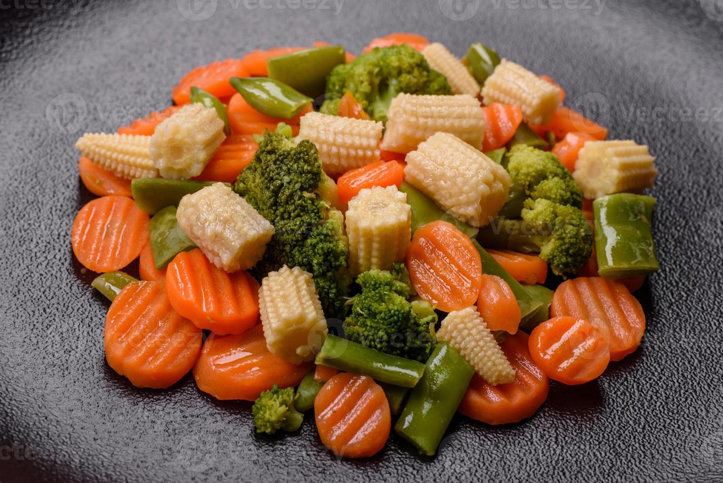 A mixture of vegetables carrots, small heads of corn, asparagus beans steamed photo