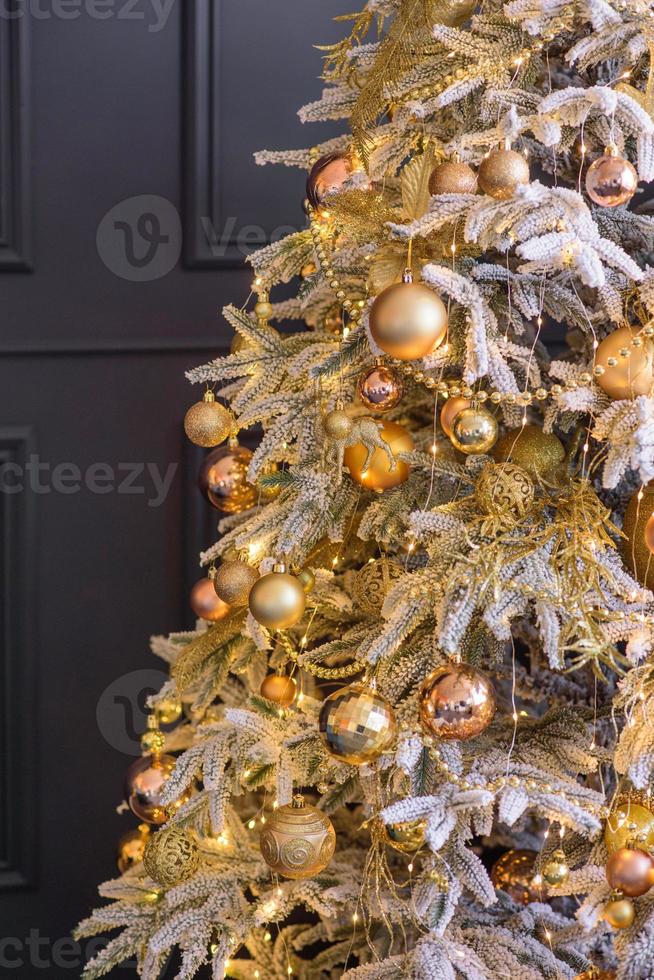 Beautiful Christmas tree with garlands, balls and toys photo