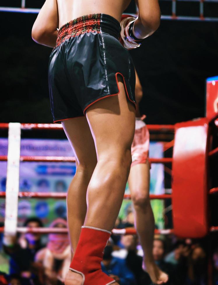 Muay Thai fighting on the boxing ring photo