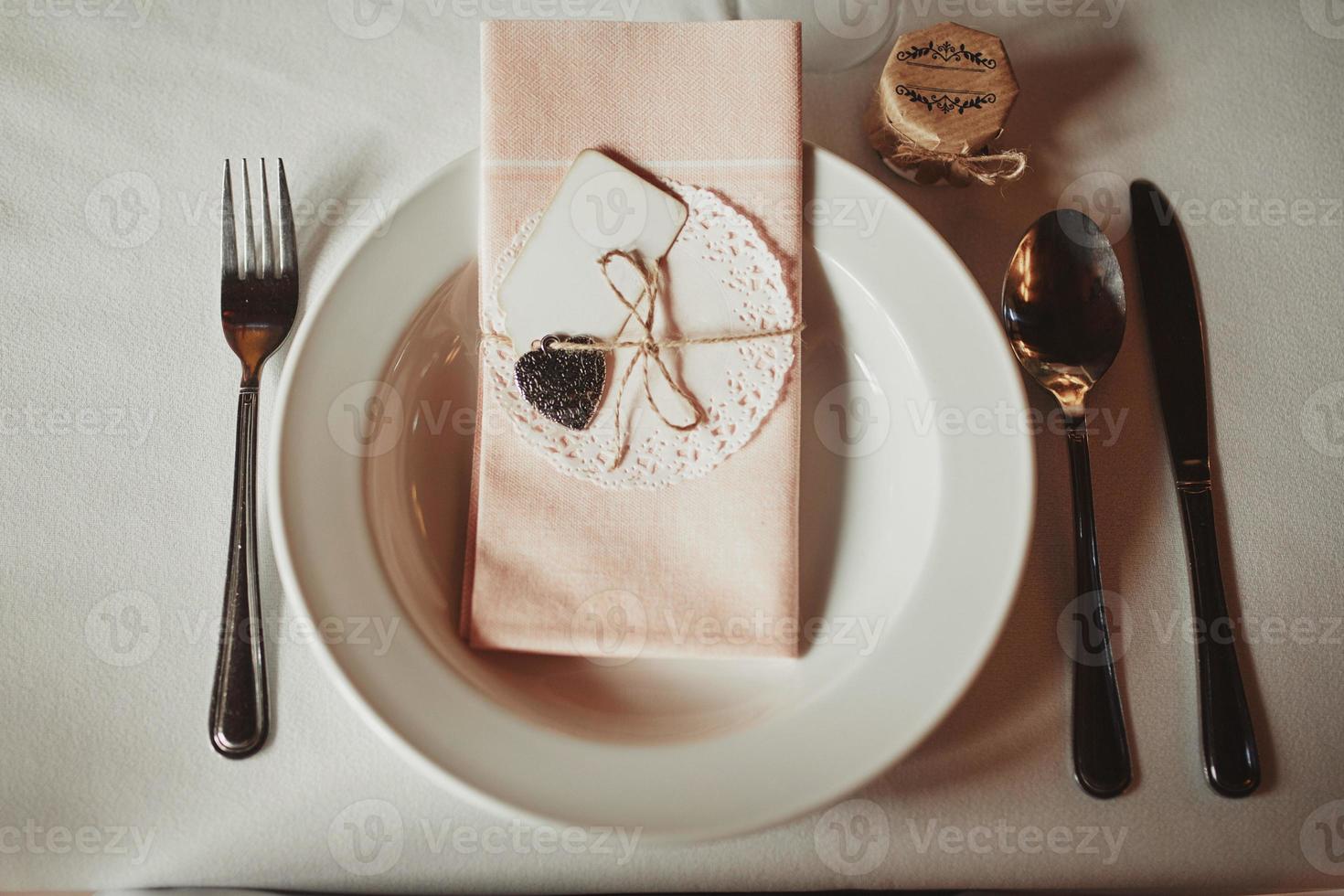 Festive table setting for Valentine's Day with fork, knife and hearts photo