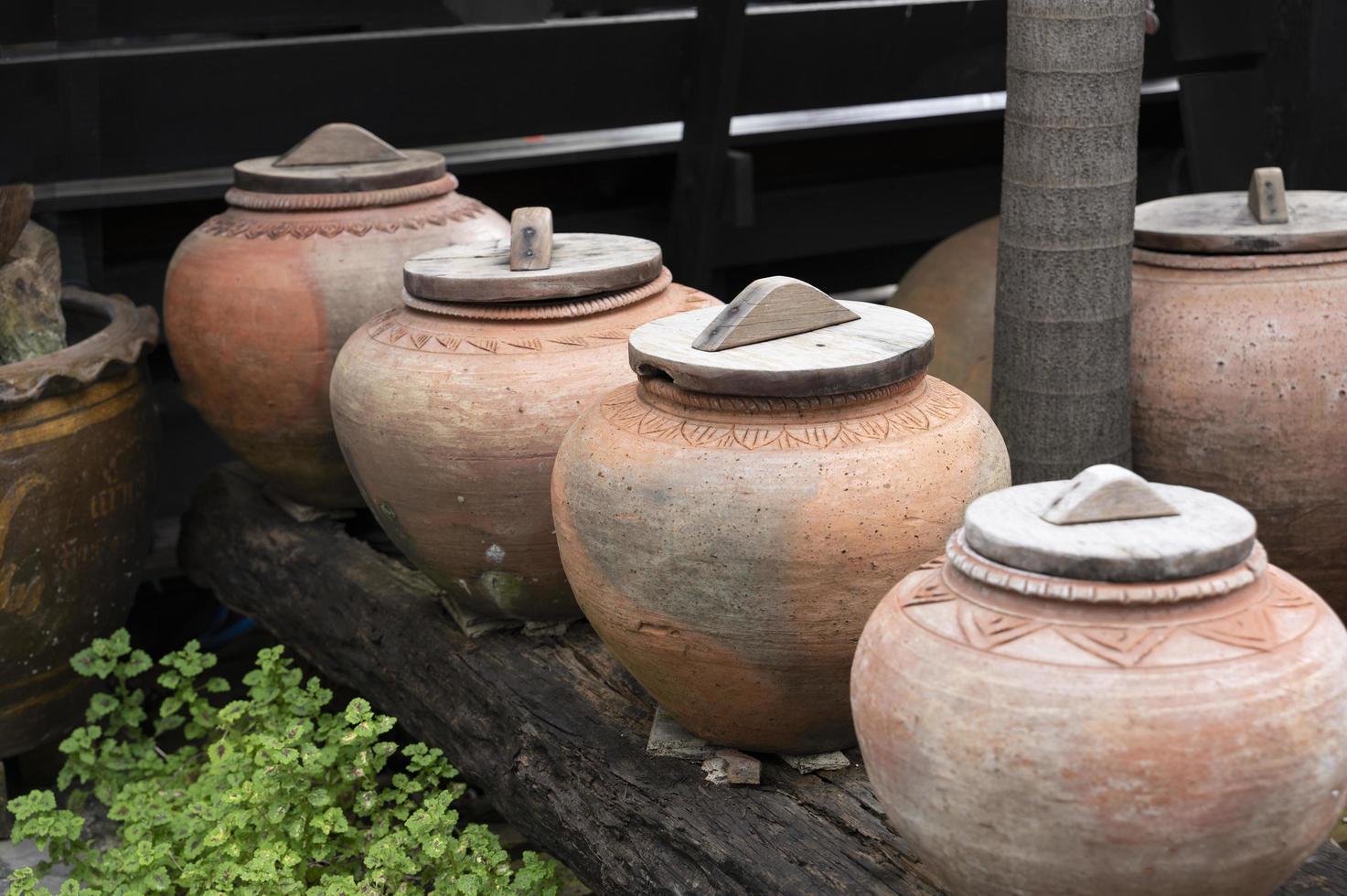 symbol of several jars with wooden lids on top photo