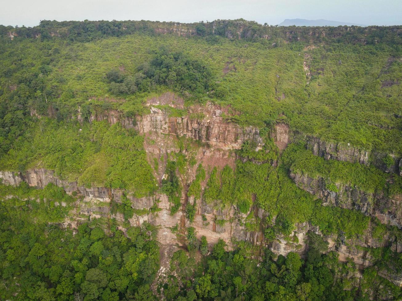 Aerial top view forest tree, Cliff large on the mountain in Asian rainforest ecosystem and healthy environment concept and background, Texture of green tree forest view from above photo