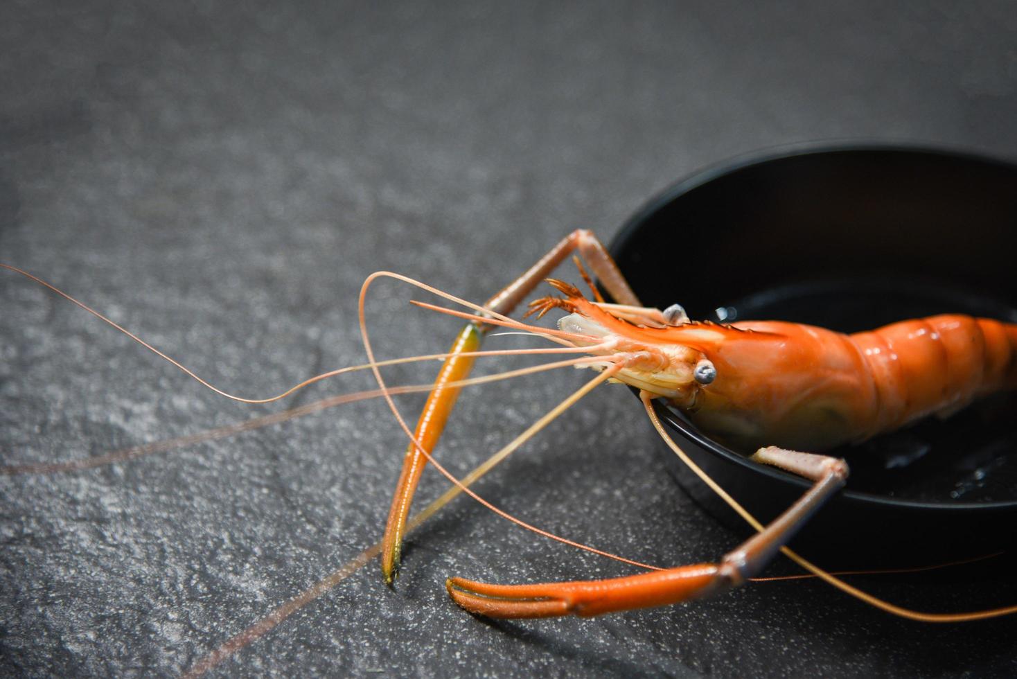 Plato de marisco con gambas gambas océano cena gourmet mariscos cocidos gambas hervidas en una sartén oscura foto