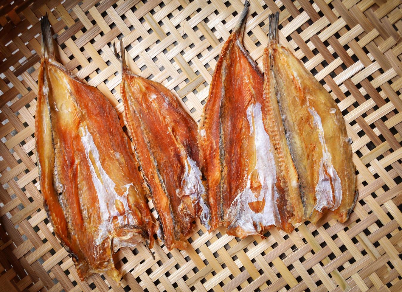 Making dried fish dry salted fish on threshing basket background photo