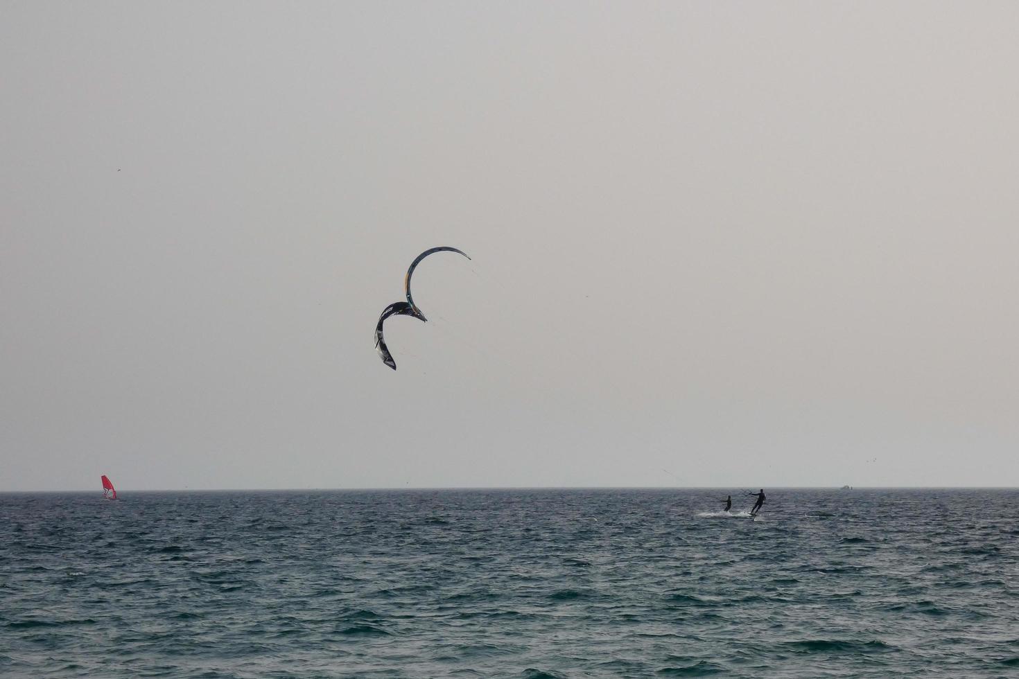 windsurfing, kitesurfing, water and wind sports powered by sails or kites photo