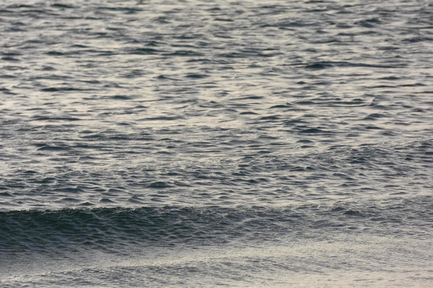 lonely, uncrowded beach with calm sea and small waves photo