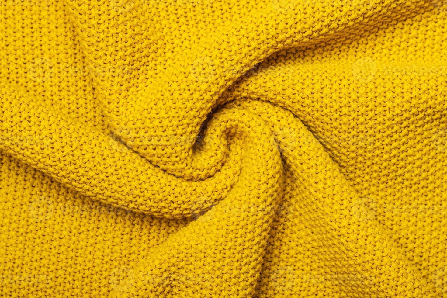 Bright yellow macro photo of textured jersey and knitting of sweater or sweatshirt. Pattern and background for fashion Warm Autumn concept