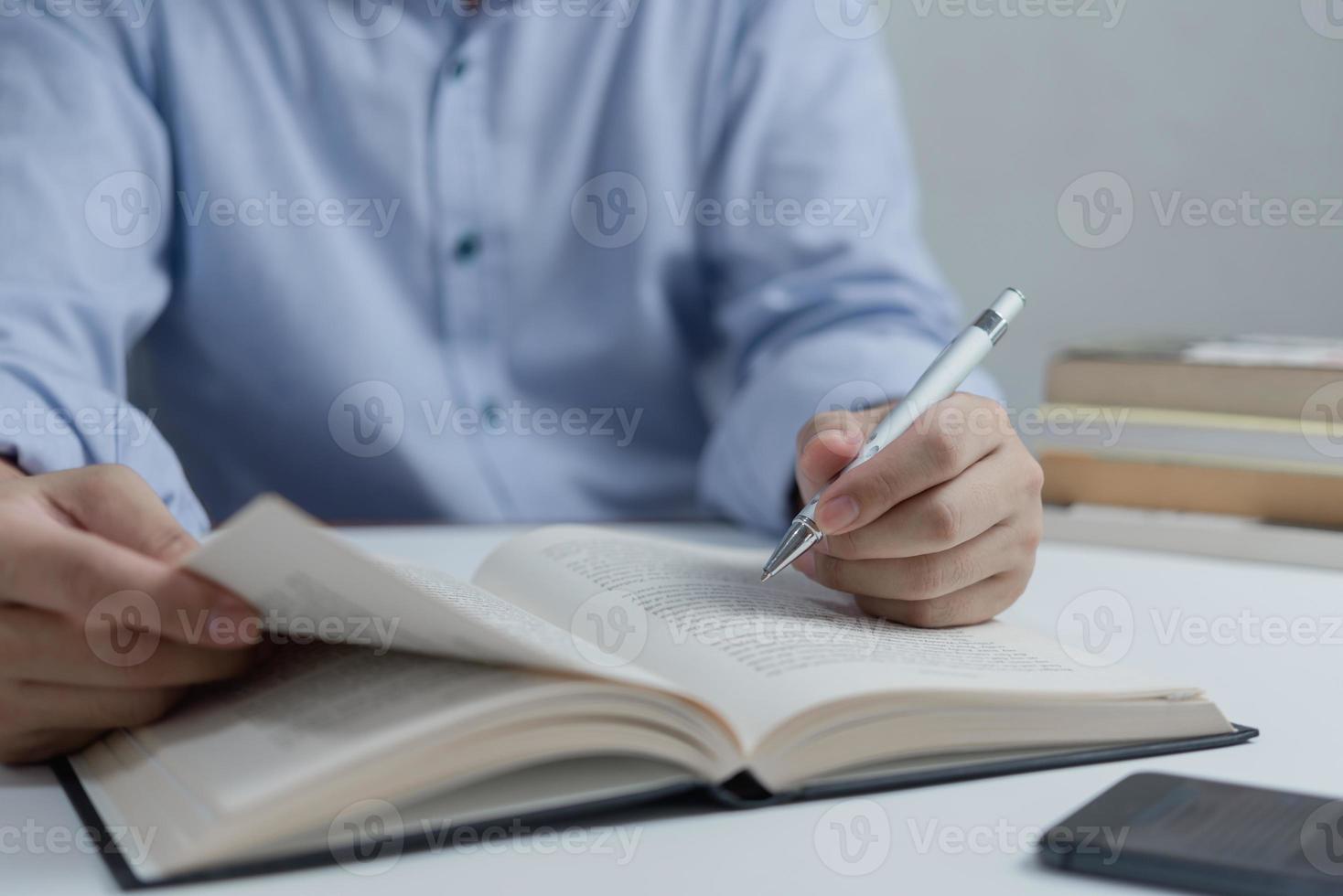 Businessperson reading and writing on book.education studying knowledge development and cognition learning concept. photo