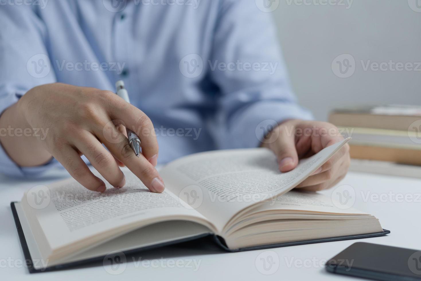 Businessperson reading and writing on book.education studying knowledge development and cognition learning concept. photo