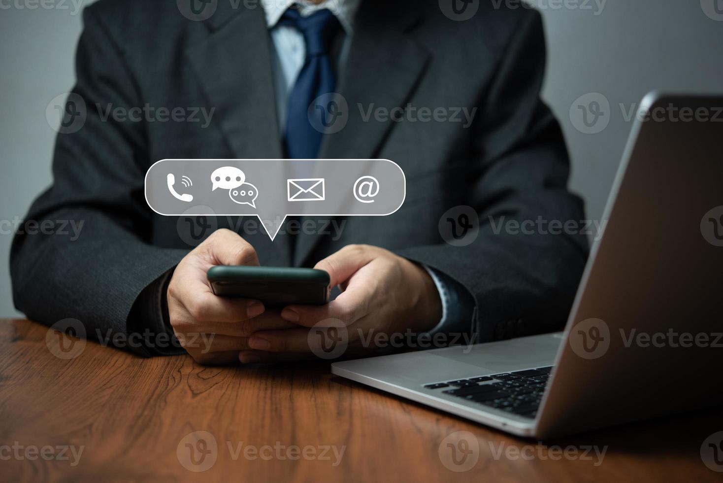 Businessperson using smartphone device to contact Information.business concept of contact us messaging calling email, with graphic icon. photo