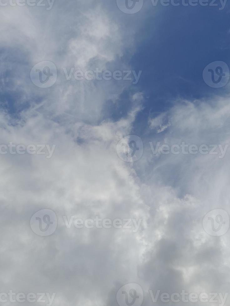 Beautiful white clouds on deep blue sky background. Elegant blue sky picture in daylight. Large bright soft fluffy clouds are cover the entire blue sky. photo