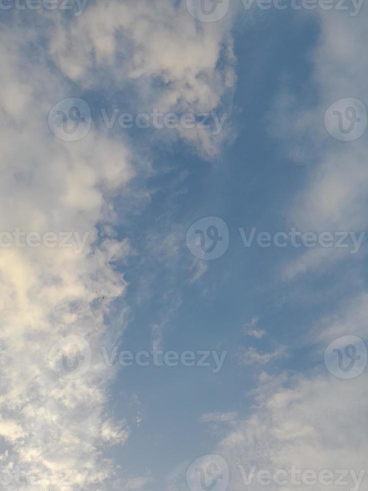 Beautiful white clouds on deep blue sky background. Elegant blue sky picture in daylight. Large bright soft fluffy clouds are cover the entire blue sky. photo