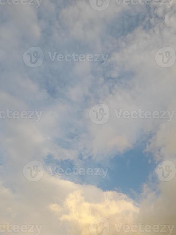 Beautiful white clouds on deep blue sky background. Elegant blue sky picture in daylight. Large bright soft fluffy clouds are cover the entire blue sky. photo