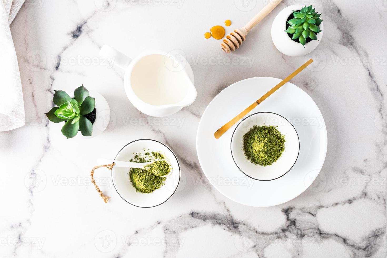 Top view of various containers with organic green matcha tea powder to prepare a delicious healthy drink. Detox. photo