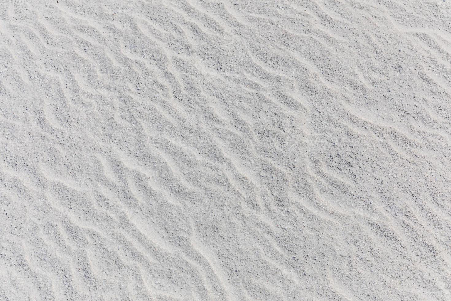 Close up sand texture on beach in summer. White sand natural beach pattern photo