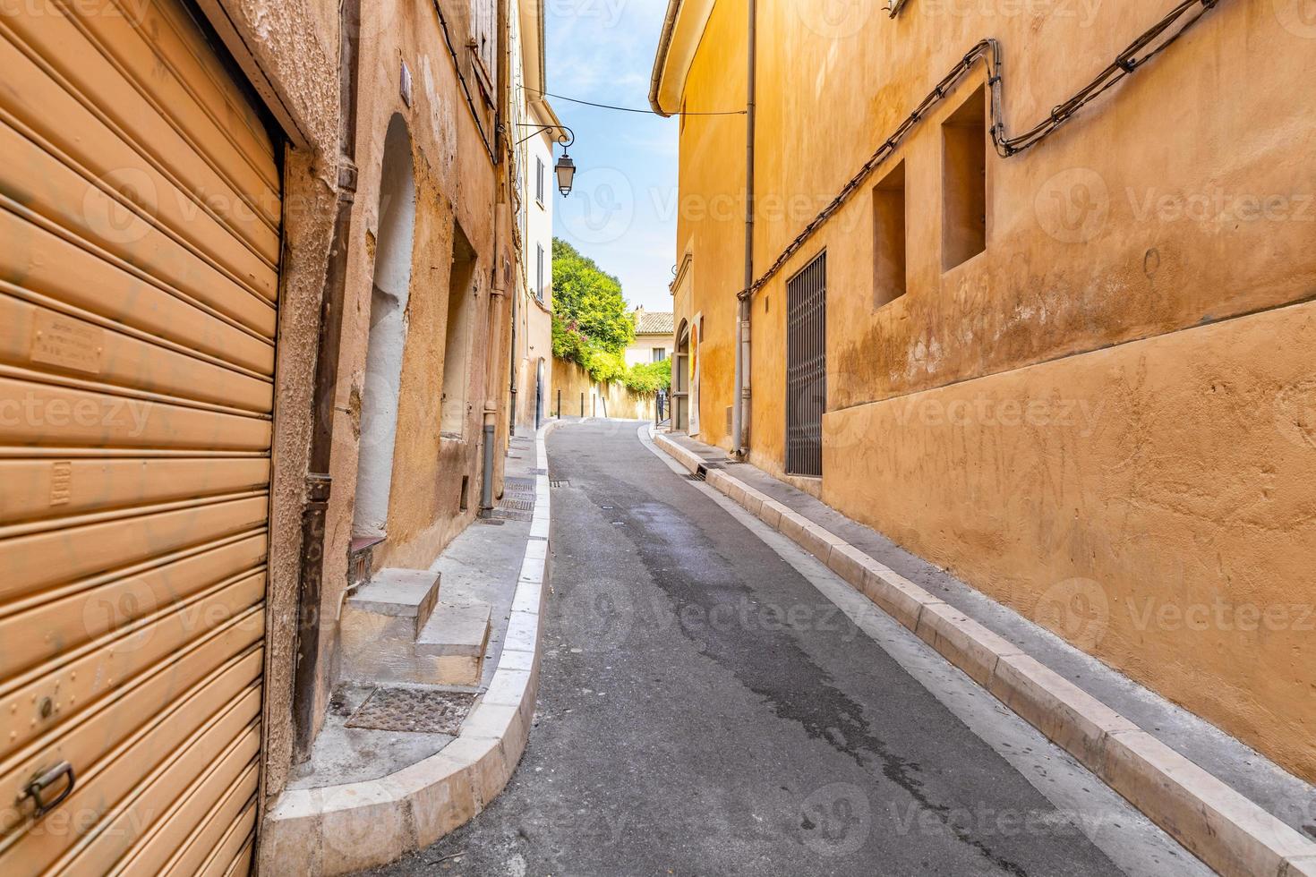 View of streets. Cozy idyllic street with doors and colorful walls. Traditional south, Mediterranean buildings and narrow streets photo
