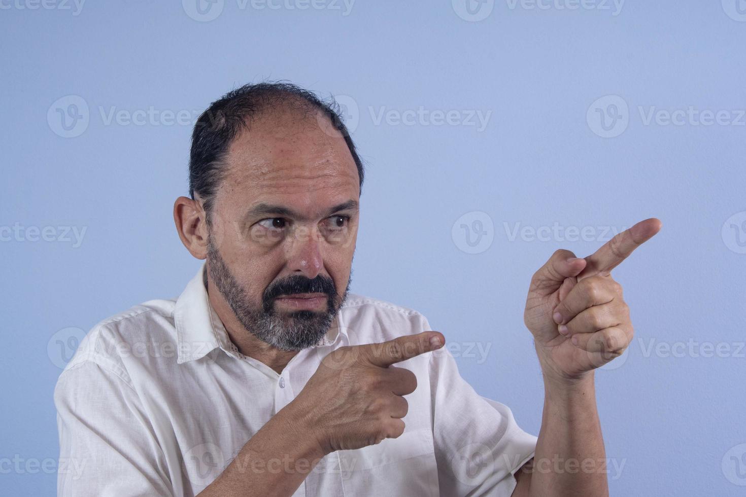 Portrait of 60 years old bearded man on blue background photo