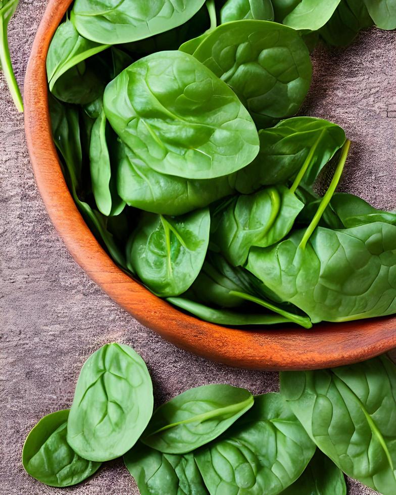 Fresh spinach Leaves on Wooden Table photo