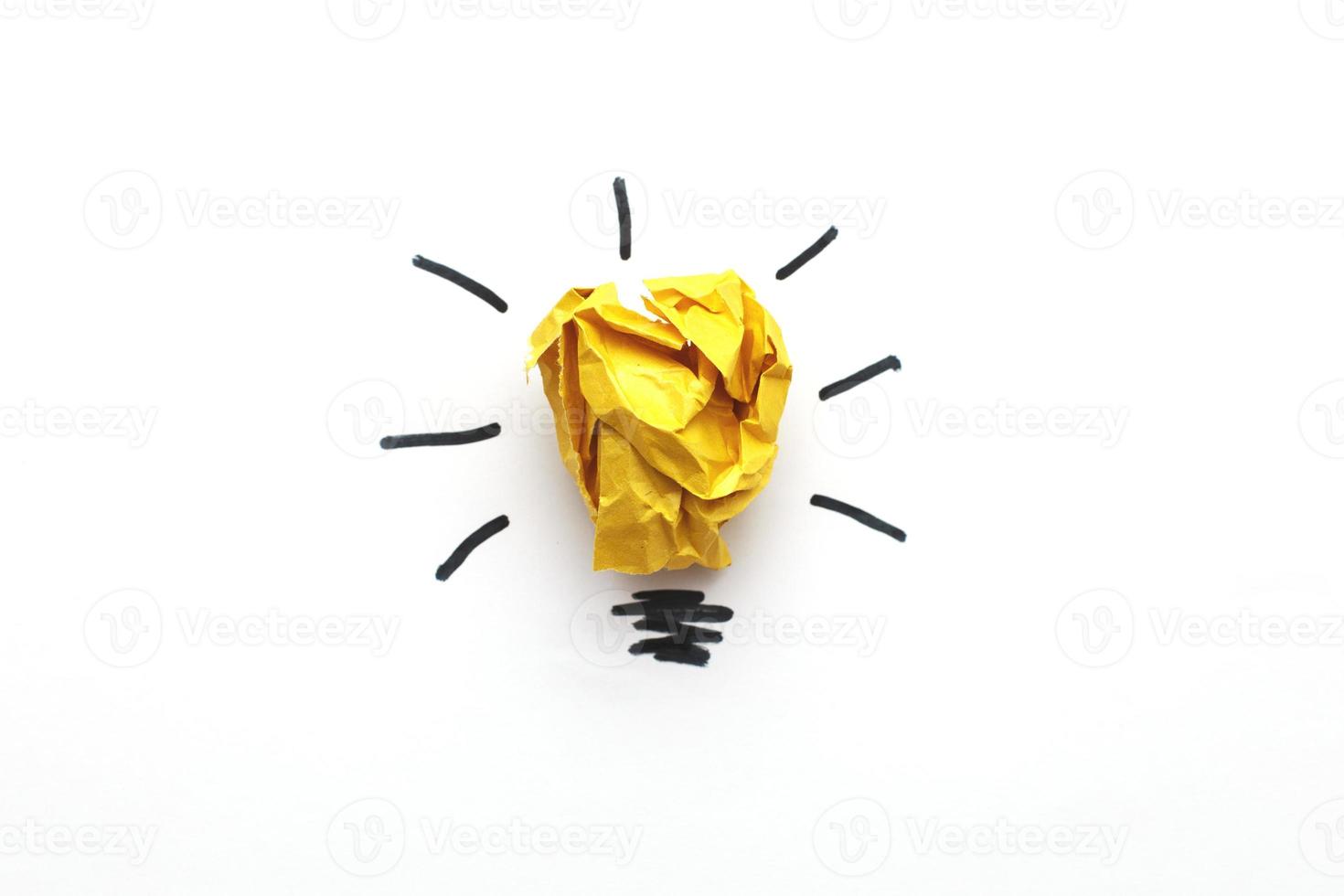 crumpled yelllow paper laightbulb as a concept creative idea and innovation photo