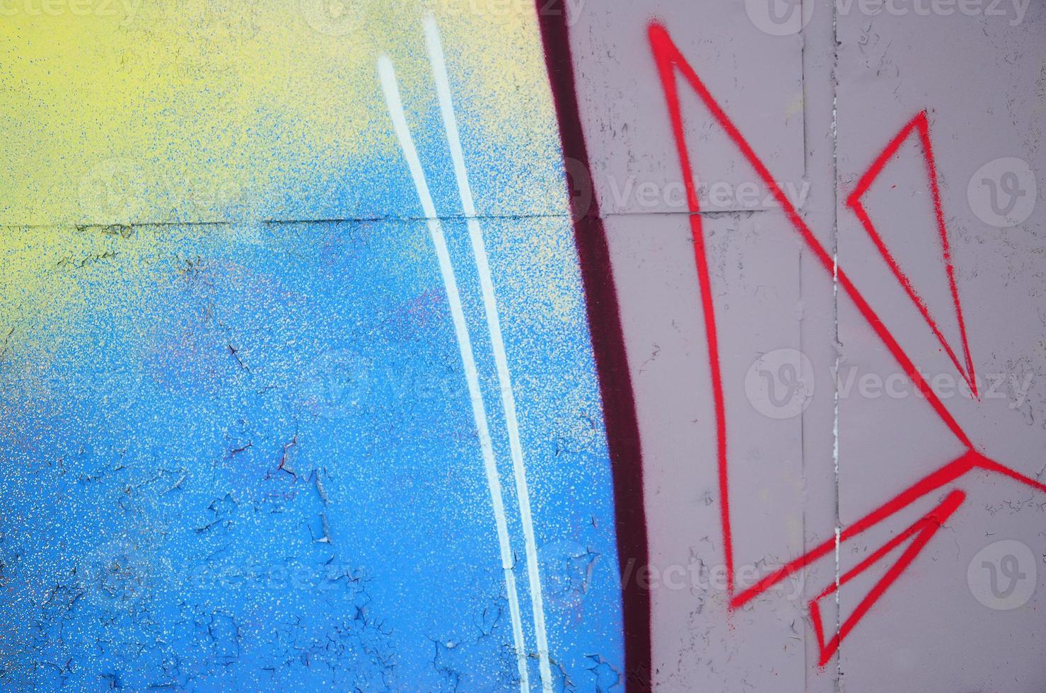 Close-up fragment of a graffiti drawing applied to the wall by aerosol paint. Background image of a modern composition of lines and colored areas. Street art concept photo